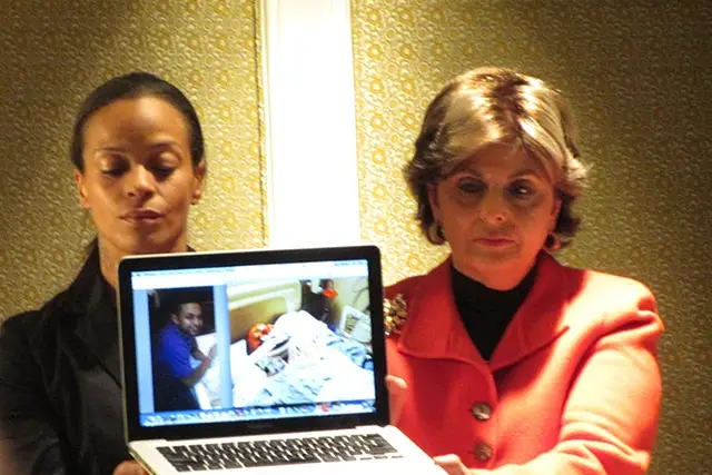 Allred and Dayana Mejia hold a laptop showing a hospitalized Edwin Mieses.